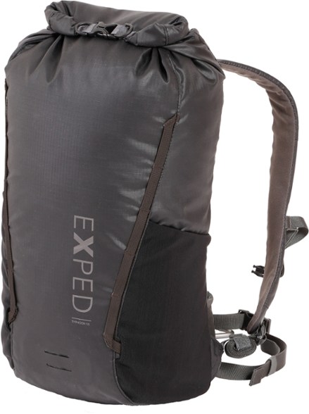 Typhoon 15 daypack in use during a rainy hike, showcasing its waterproof features.