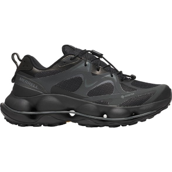 Side view of waterproof women's hiking shoes with Vibram sole navigating a wet forest trail.
