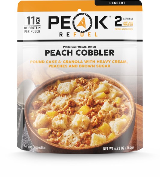 PEAK REFUEL Peach Cobbler Delight served in a bowl at a campsite, highlighting its tempting appearance.