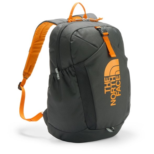 North Face Mini Recon kids backpack in use on a hiking trail with water bottle pockets visible.
