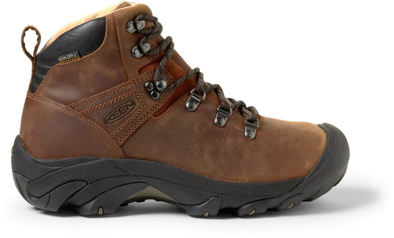 Side view of KEEN Pyrenees men's hiking boots on rocky terrain.