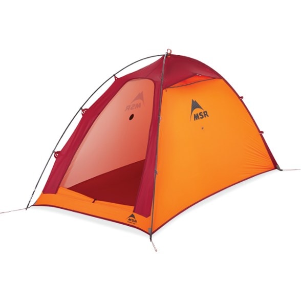 Alpine Pro 2 tent pitched on a narrow ledge in the mountains, demonstrating its compact design.