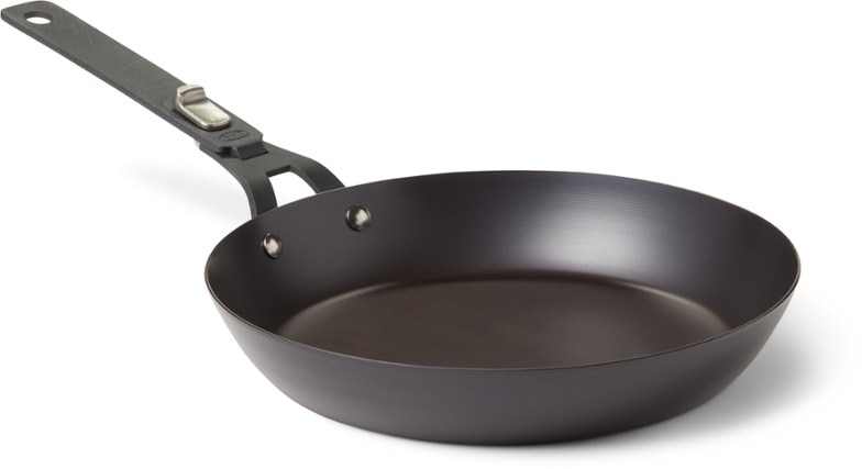 10-inch carbon steel frying pan with detachable handle on a campfire grill