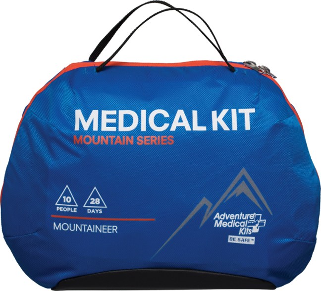 Ultimate Mountaineering Medical Kit displayed outdoors with hiking gear.