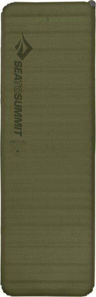 Camp Plus self-inflating sleeping pad in a serene camping environment, highlighting its thickness and comfort.