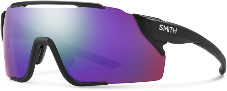 ChromaPop Attack MAG MTB sunglasses with blue lenses at a mountain biking trail, highlighting the quick-release feature.