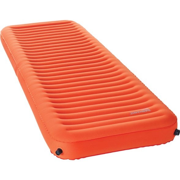Therm-a-Rest NeoLoft sleeping pad showcased in a tent, with mountains in the background, highlighting its lightweight design.
