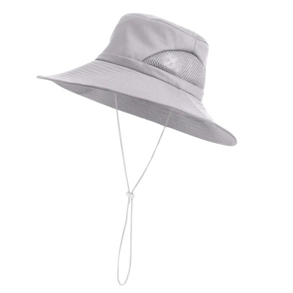 Chic waterproof sun hat with satin lining displayed on a beach, showcasing its stylish design.