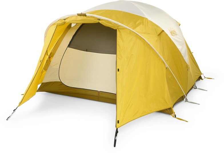 Base Camp Pro 4-person tent pitched in forest clearing showcasing durable weather-resistant fabric and spacious interior