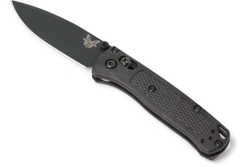 Benchmade Mini Bugout knife displayed on a wooden surface, highlighting its sleek design.