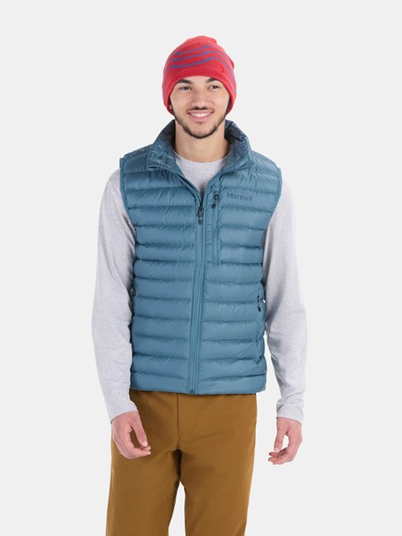 Marmot Highlander Down Vest showcased on a model outdoors, highlighting its stylish cut and functionality.
