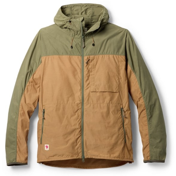 Fjallraven Men's Coastal Windproof Jacket displayed on a hiking trail, highlighting its windproof features.