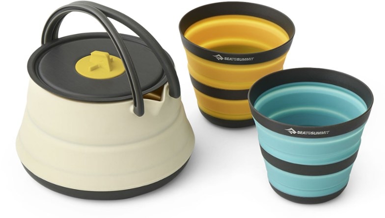 UltraLight camping cookset with collapsible kettle in a scenic outdoor setting.