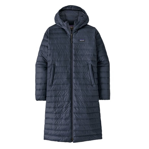 Patagonia women's down parka shown in a snowy landscape, perfect for winter travel.