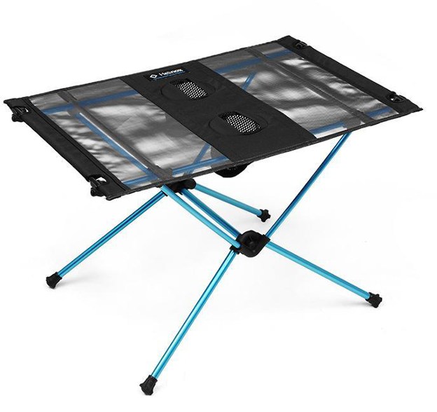 Lightweight picnic table set up with cup holders in a park
