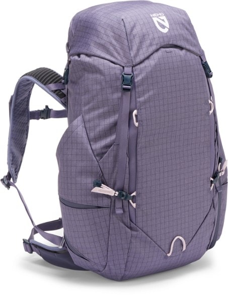 NEMO Resolve 35L backpack in use on a hiking trail, highlighting its comfort and storage features.