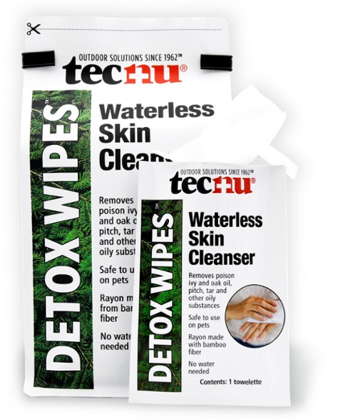 Hand holding ClearTrail detox wipes against a forest backdrop – ideal outdoor skin cleanser