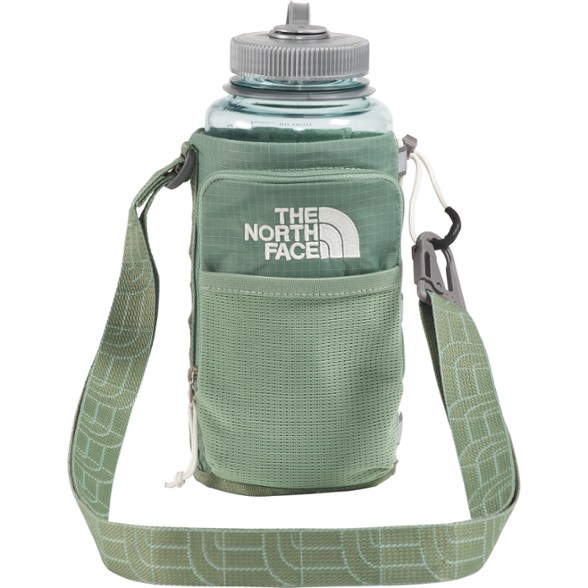 Side view of the adjustable bottle pouch with bungee strap holding a water bottle securely