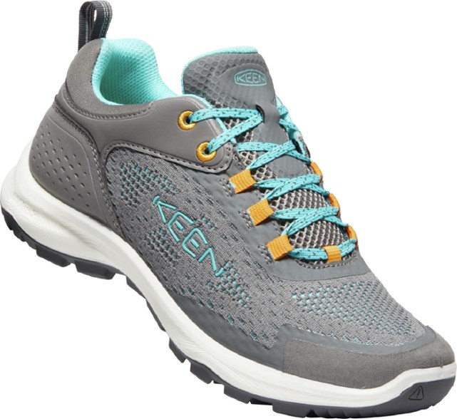 Side view of KEEN Women's Terradora Speed hiking shoes on a rocky trail, highlighting their lightweight design.