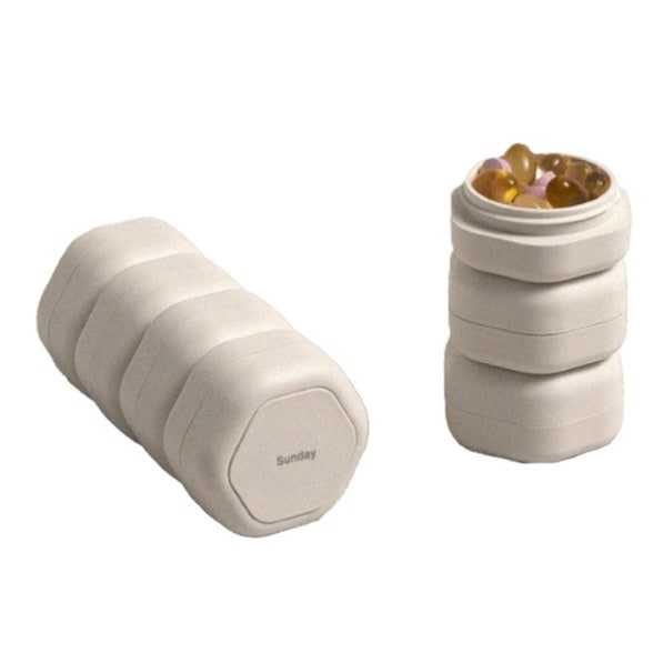 Weekly pill organizer with labels showing compartments for each day of the week.
