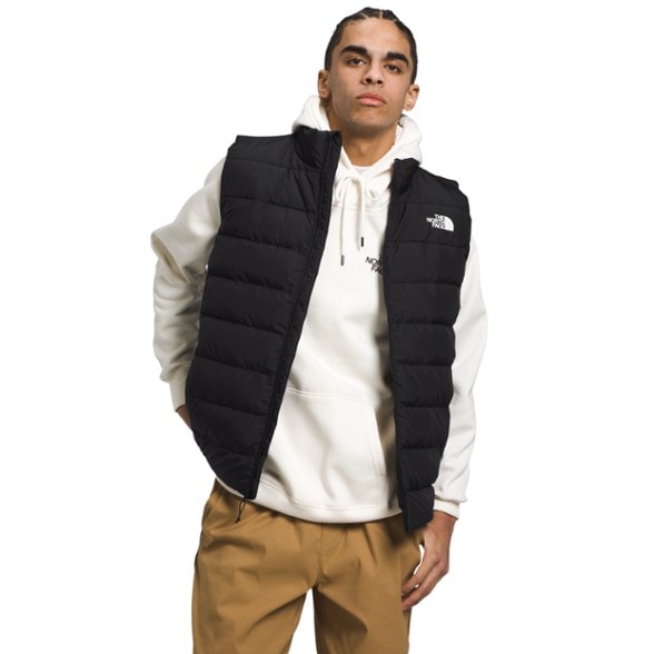 Front view of men's North Face insulated vest worn during winter hike