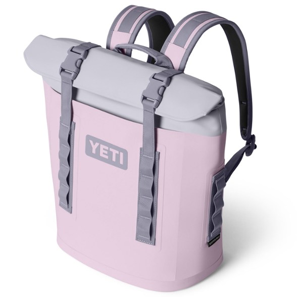 YETI Hopper M12 Backpack Cooler in an outdoor setting with wine bottles inside.