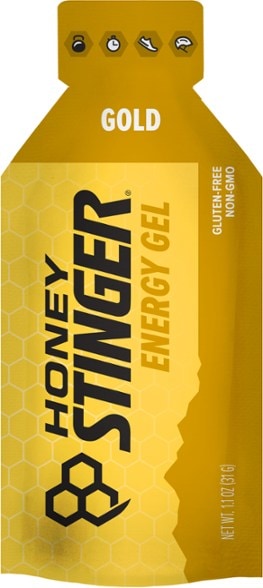 Honey Stinger energy gel packet displayed in an outdoor setting for cyclists.
