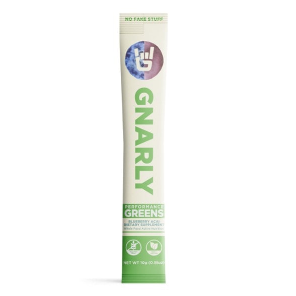 Gnarly Performance Greens in a glass of water, showcasing vibrant green color for energy boost