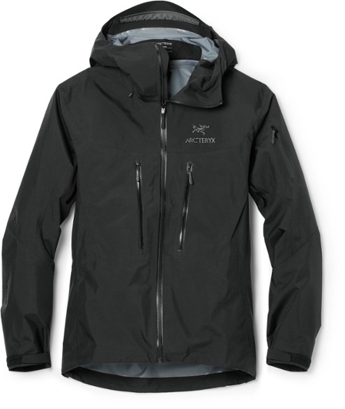 Men's GORE-TEX climbing jacket displayed in a rugged mountain setting, highlighting its waterproof features.