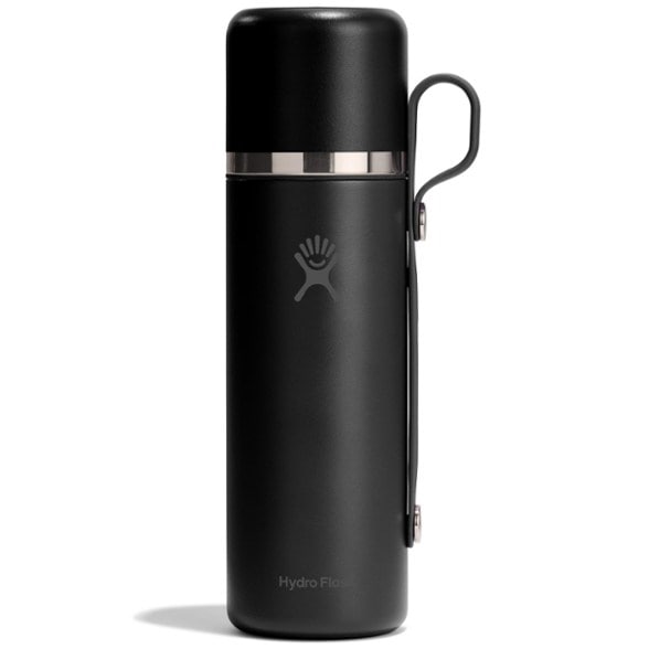 Adventure insulated water bottle displayed outdoors with mountains in the background.