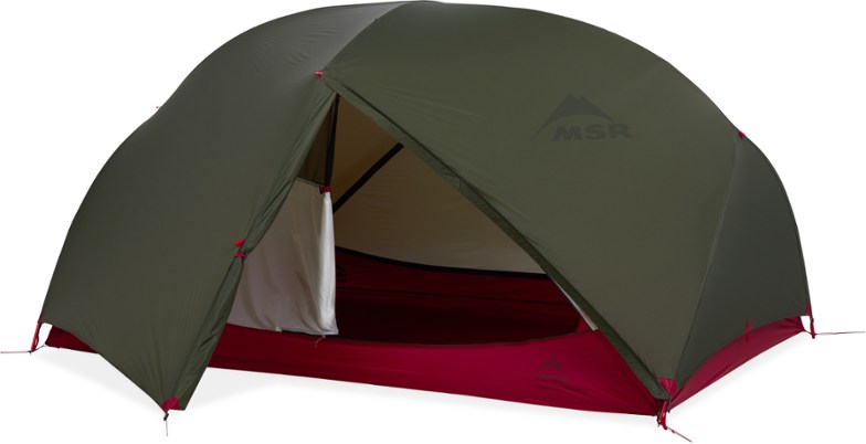 Side view of TrailBlaze Duo lightweight tent pitched beside a bike on a forest trail, showcasing large vestibules for gear storage