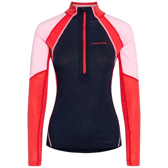 Alma women's half-zip base layer top in action during skiing, showcasing its moisture-wicking fabric.