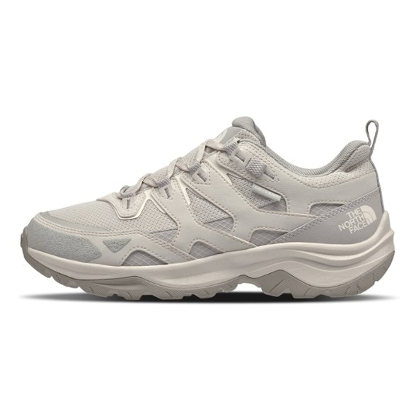 Side view of women's waterproof hiking shoes with extra cushioning on rocky trail