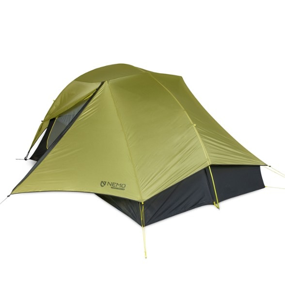 NEMO Hornet 3P tent set up in a scenic camping spot, showcasing its spacious interior and gear coverage.