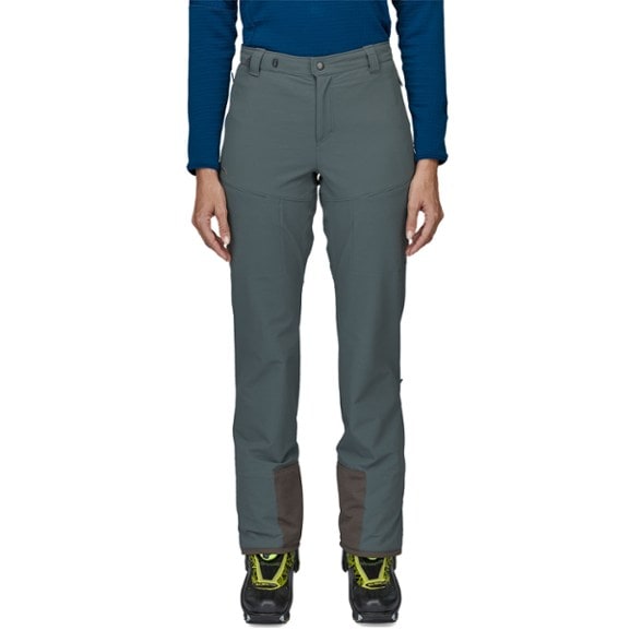 Front view of women's alpine pants with adjustable boot cuffs and zippered vents for ski touring