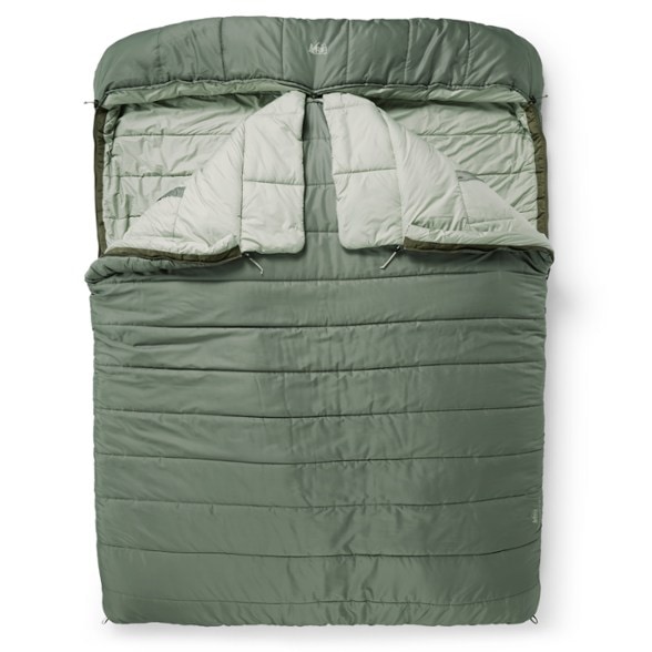 CozyNest Hooded 20 Double Sleeping Bag in a cozy camping setup, showcasing its spacious interior.