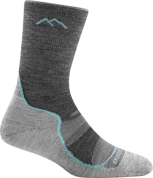 Side view of women's breathable hiking socks for boots on rocky trail.