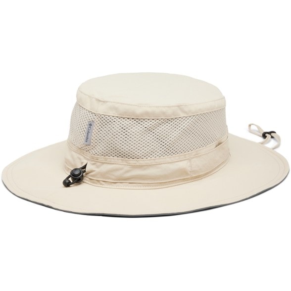 Columbia Bora Bora Booney II sun hat shown on a beach with a person wearing it, showcasing its sun protection features.