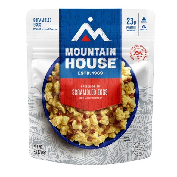 Top-down view of the freeze-dried scrambled eggs and bacon pouch opened with steam rising