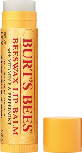 Close-up of peppermint beeswax lip balm on a wooden surface, highlighting its natural ingredients.