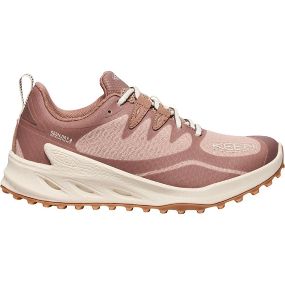 Side view of Zionic women's lightweight hiking shoes on rocky terrain.