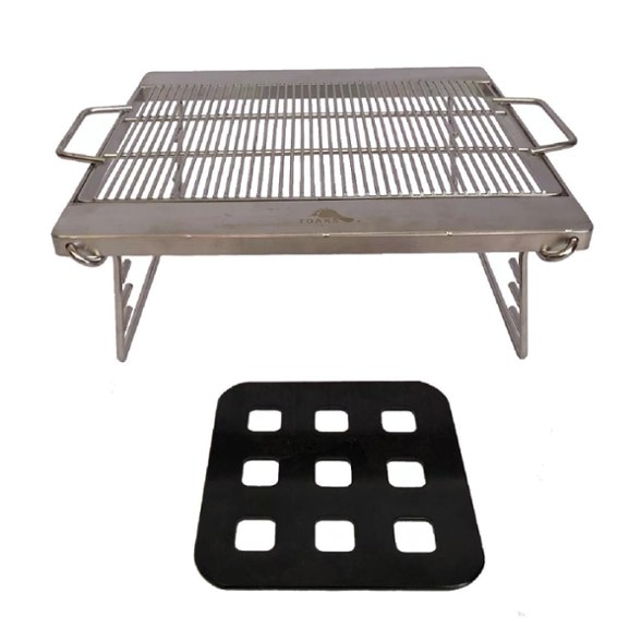 TOAKS Adjustable Camping Grill Attachment set up on a portable fireplace, showcasing its three height levels.