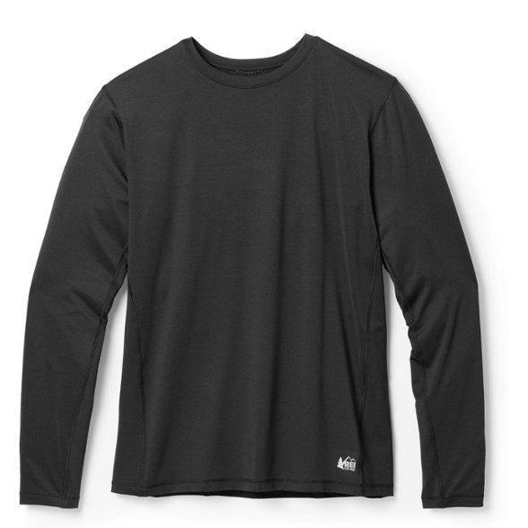 Men's lightweight base layer top in action during a hike, showcasing its moisture-wicking feature.