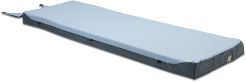 Top view of TrailNest memory foam pad laid out at a campsite, showing plush surface and rectangular shape
