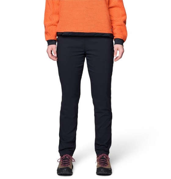 Mountain Hardwear Women's Technical Outdoor Pants on a hiking trail, demonstrating warmth and mobility.