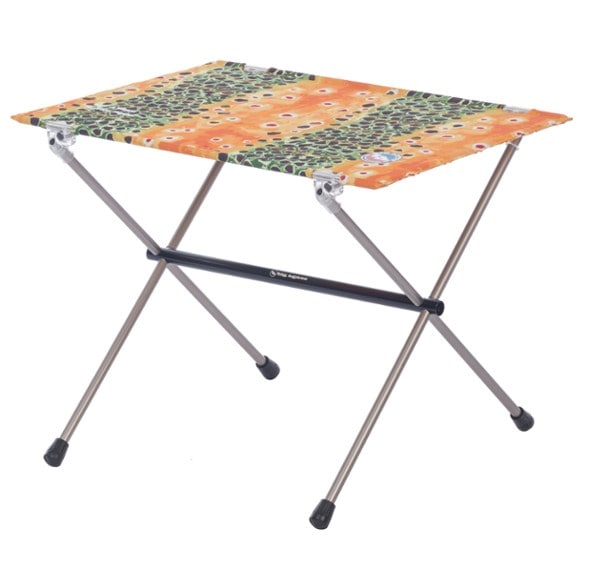 TrailNest backpacking table folded inside its compact carry bag with aluminum poles visible.