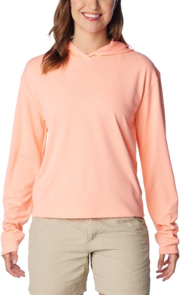 Columbia PFG Women's Cropped Sun Protection Hoodie displayed in a sunny outdoor setting, emphasizing its lightweight design.