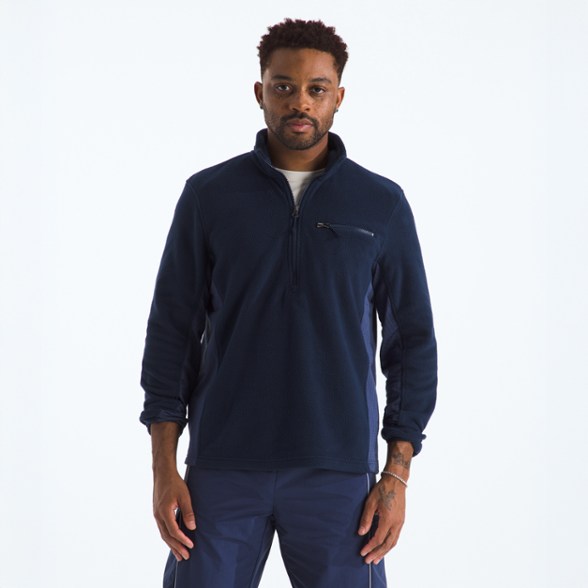 Men wearing the Summit Breeze Half-Zip fleece top while hiking in the mountains, demonstrating its comfort and breathability.