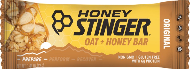 Nutty Honey Oat Energy Bar on a wooden table, showcasing the nut butter core and crunchy oats.