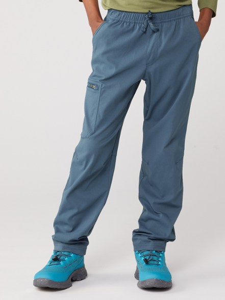 Kids hiking in Adventure Ready Pants, showcasing water resistance and flexibility.